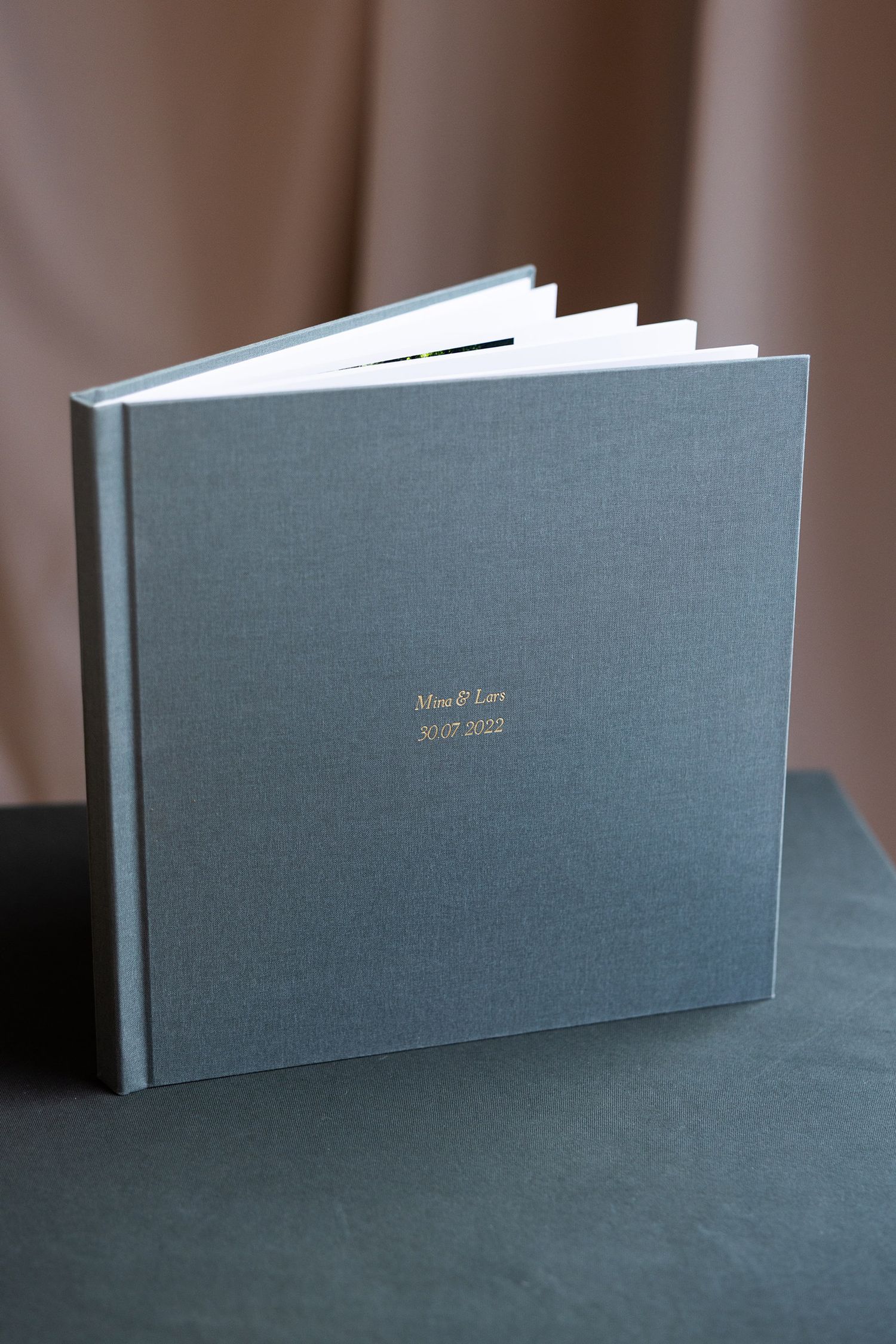 Album i 30x30 cm med sjøgrønt cover. Albumet er preget.