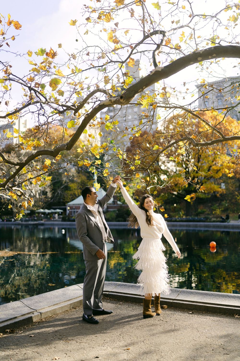 A romantic photo sequence by a lake with fall foliage and stone walls.