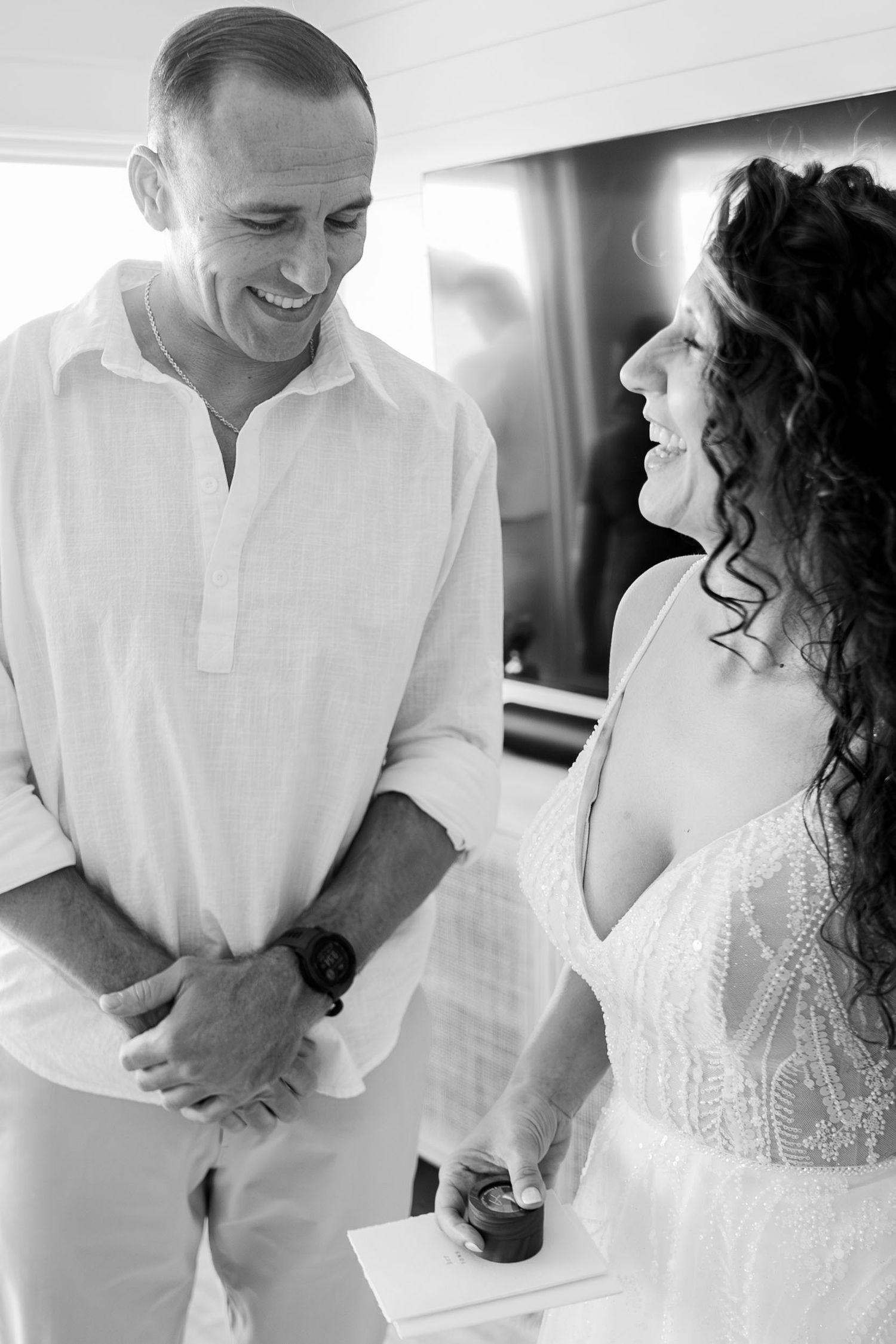 A candid black and white moment captured during wedding preparations.