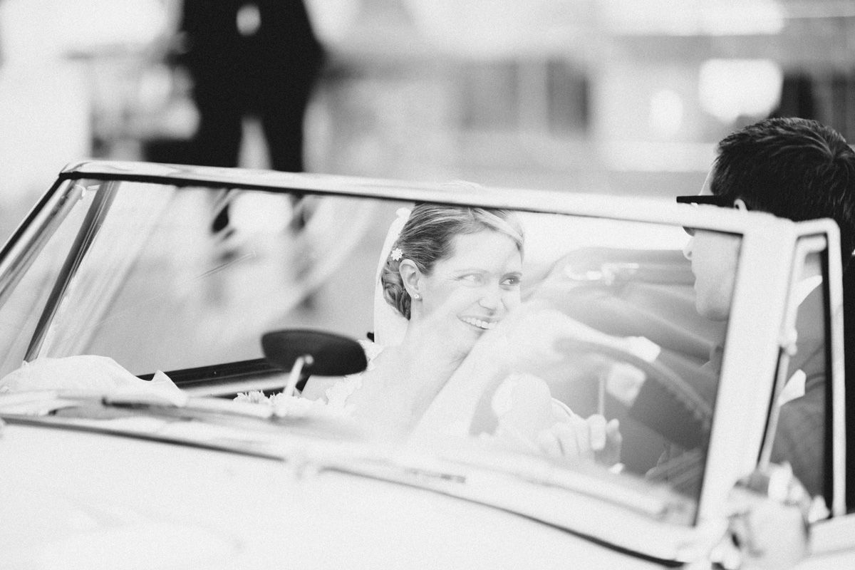 Bride and groom leaving in classic car