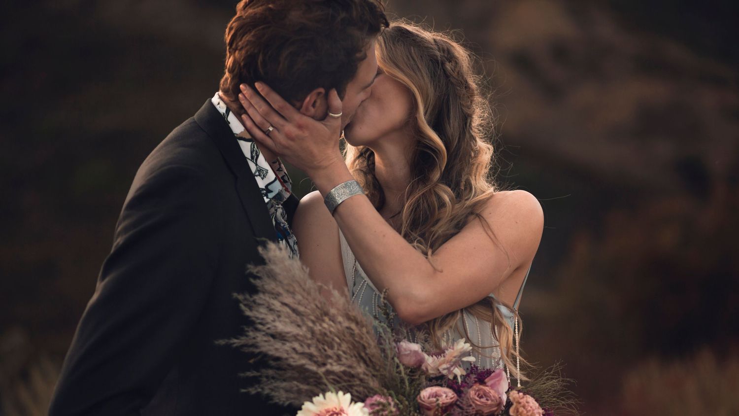couple kisses among the landscape at their outdoor, mountain intimate wedding quebec canada