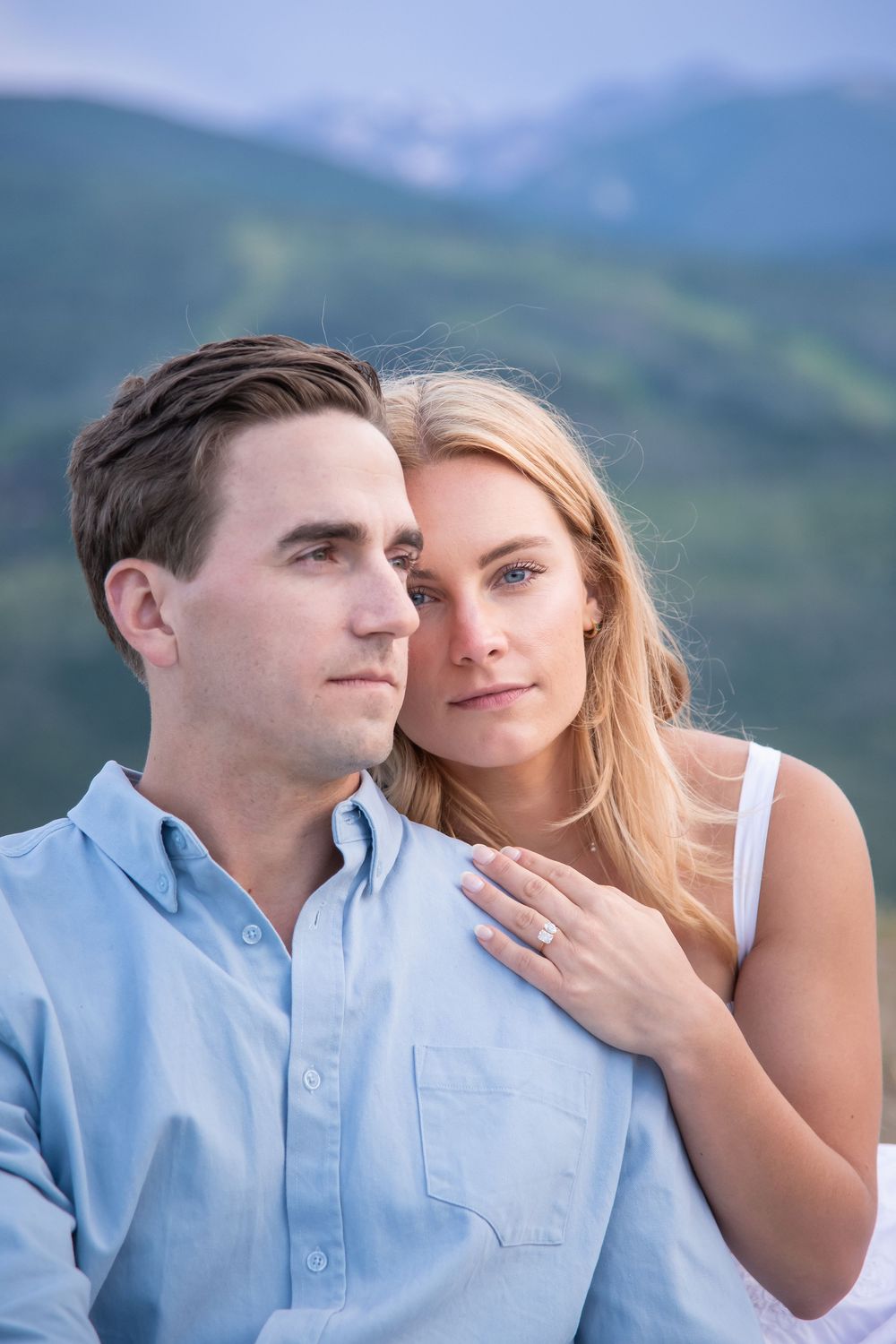 A romantic couple shares tender moments against a scenic mountain backdrop in a series of intimate photos.