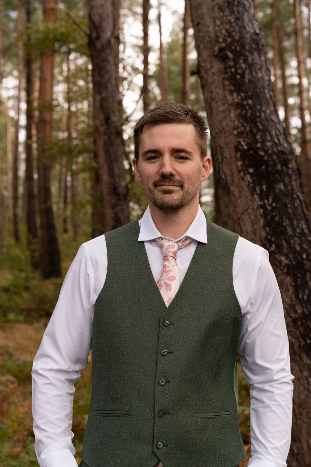 Three close-up shots of formal attire featuring a dark green vest with white shirt and pink tie.