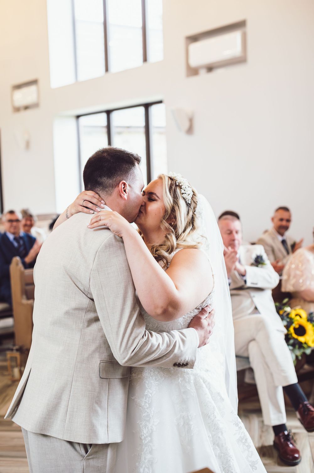 A series of romantic wedding photos showing tender moments between newlyweds during their first dance in a bright venue.