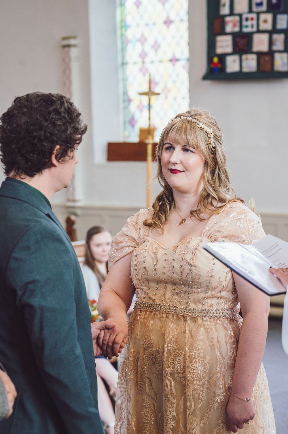 A wedding ceremony scene shows a couple exchanging vows in a bright church interior.