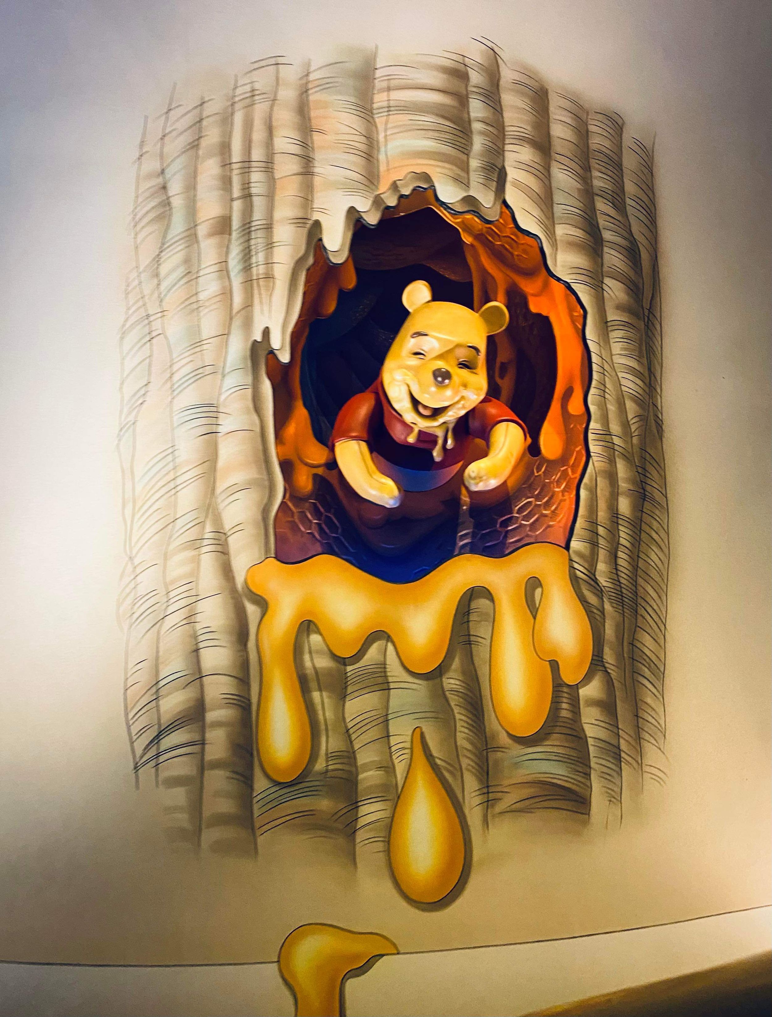 Five artistic wall sculptures depict honey dripping down from above in vibrant orange against a light textured background.