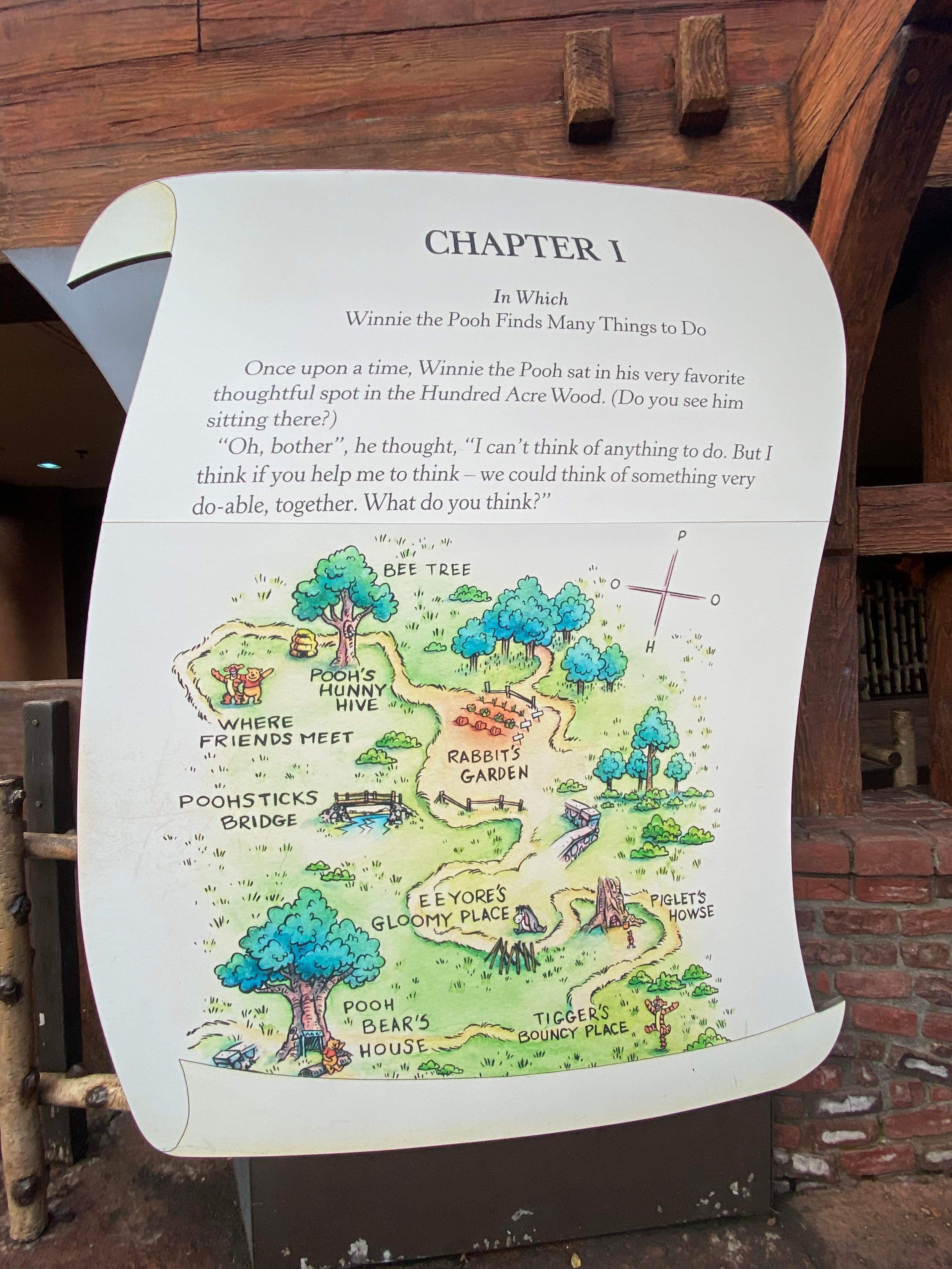 A hand-drawn fantasy map illustration on a book page titled 'Chapter 1' showing colorful trees, paths, and labeled regions.