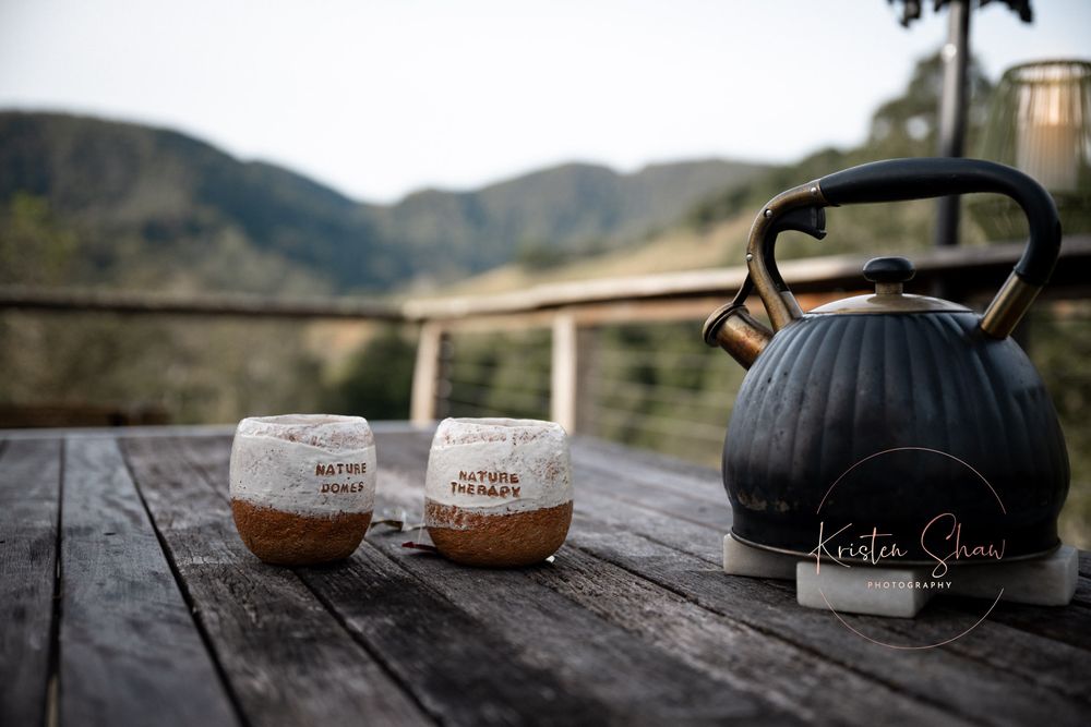 A series of six lifestyle photos showing coffee mugs on wooden surfaces in rustic outdoor settings against mountain landscapes.