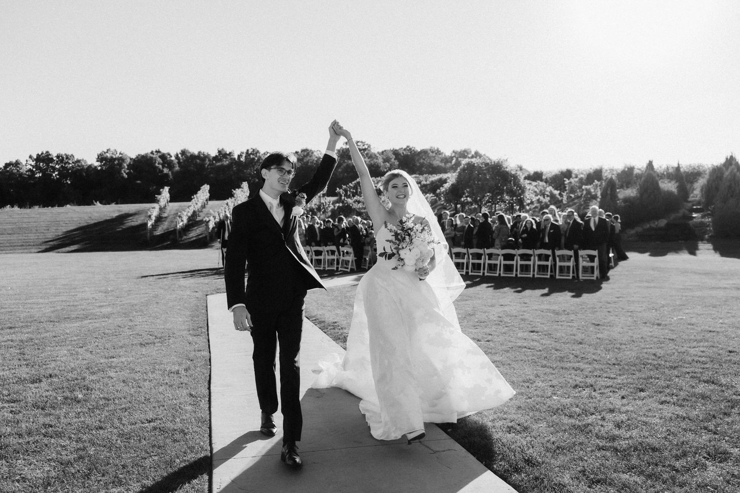 A black and white wedding photo collage showing outdoor ceremony and celebration moments at a scenic venue.