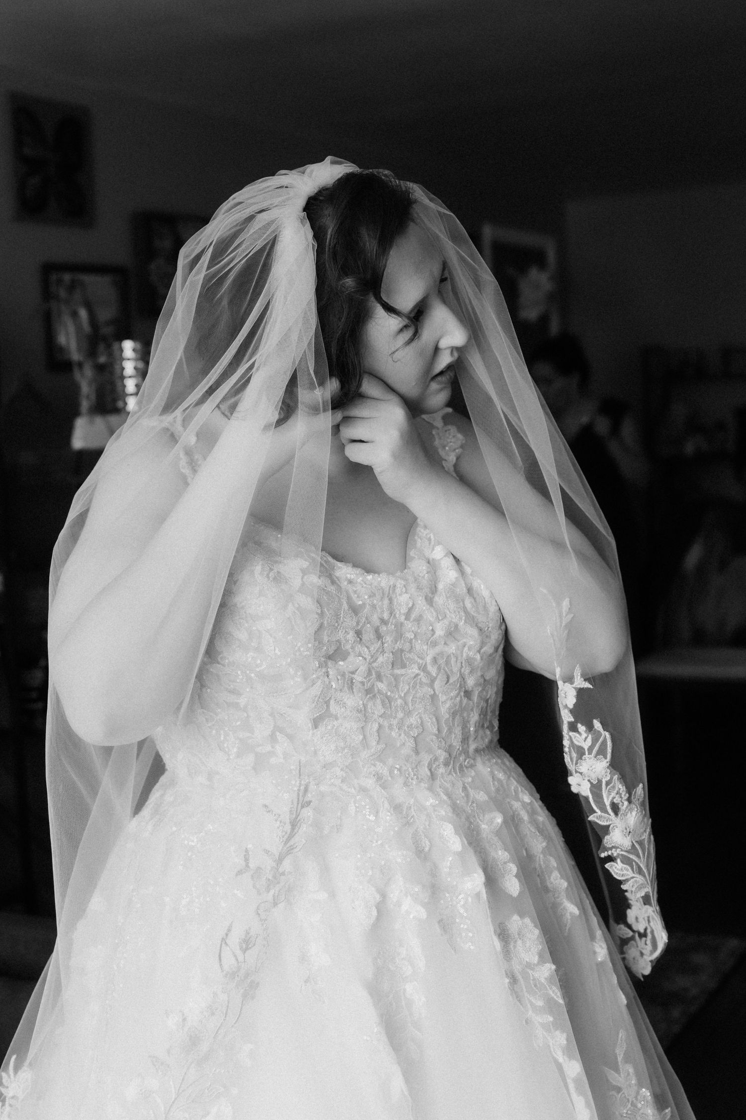 A series of black and white photographs showing the delicate details of a wedding dress and veil.