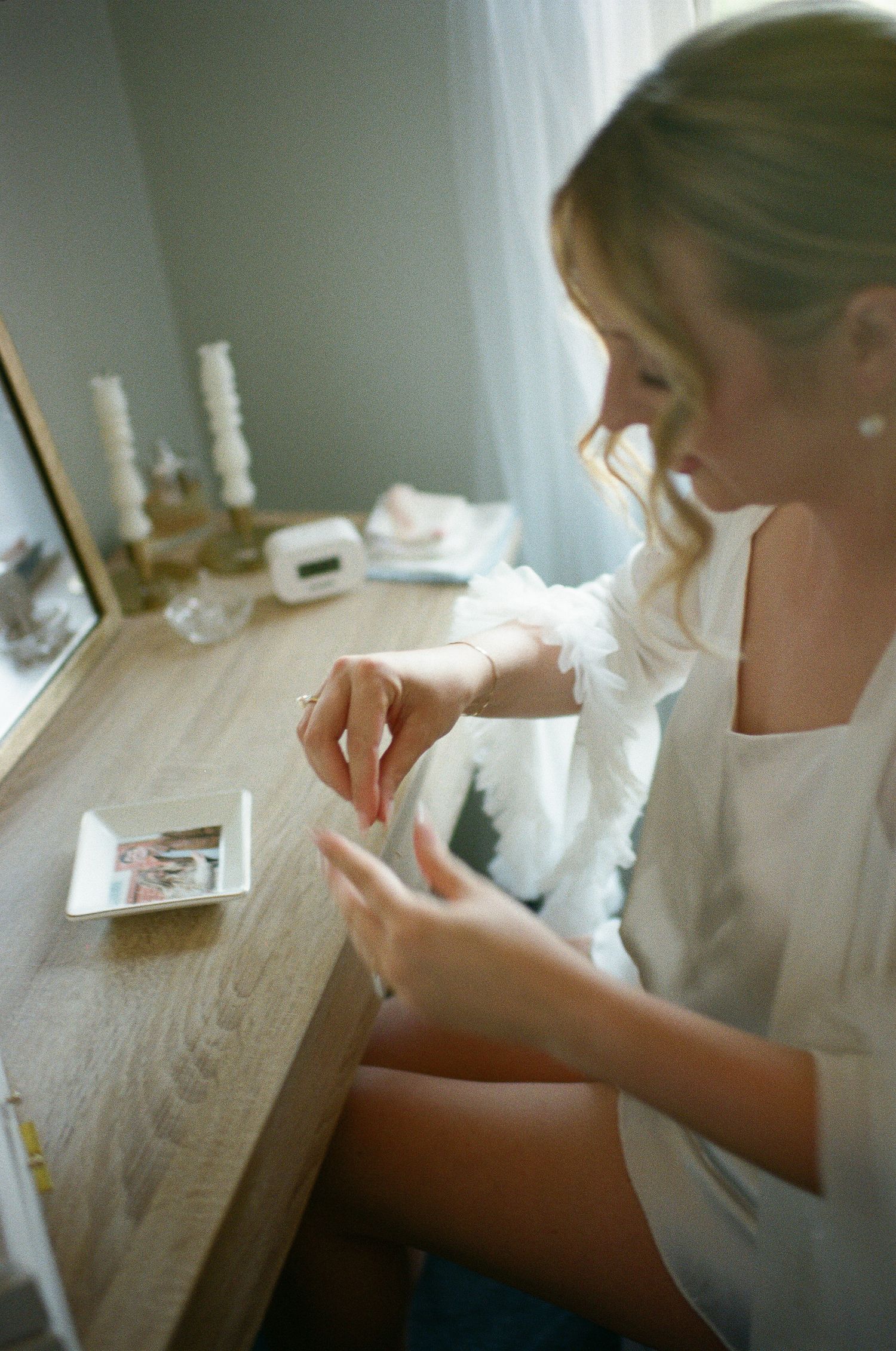 A series of close-up photographs showing someone writing at a wooden desk in natural light.