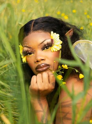 Beautiful artistic portrait series among vibrant yellow wildflowers and green grass in a dreamy outdoor setting.