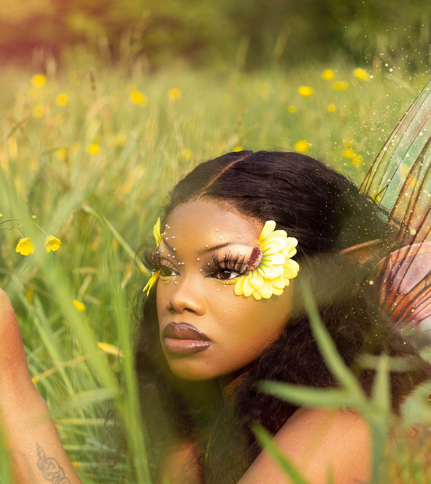 Close-up artistic portrait in a meadow with yellow flowers and soft natural lighting creates a dreamy spring atmosphere.