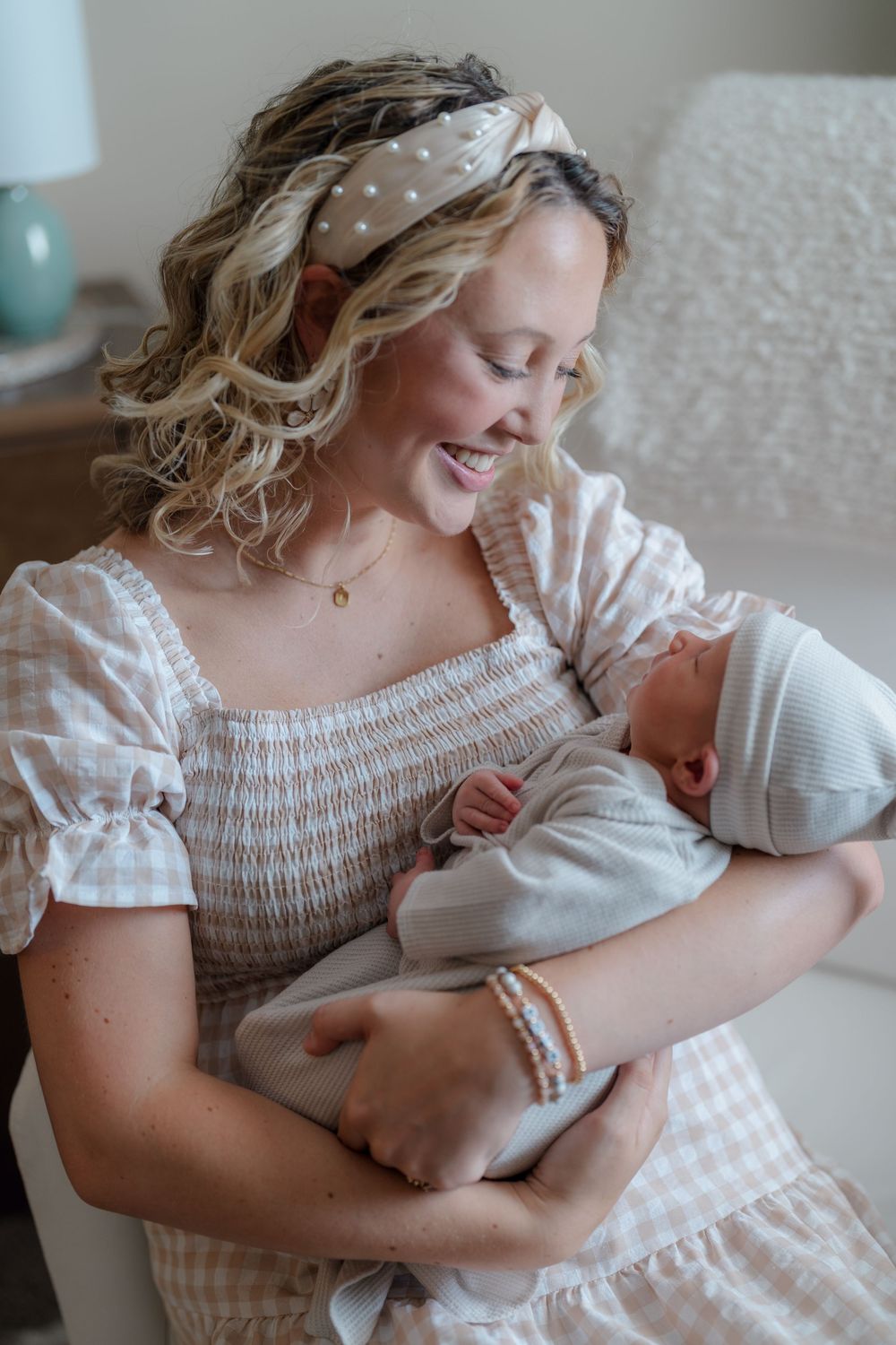 A tender family moment captured in a series of photos showing a parent cradling and bonding with a newborn in in-home photography session OH