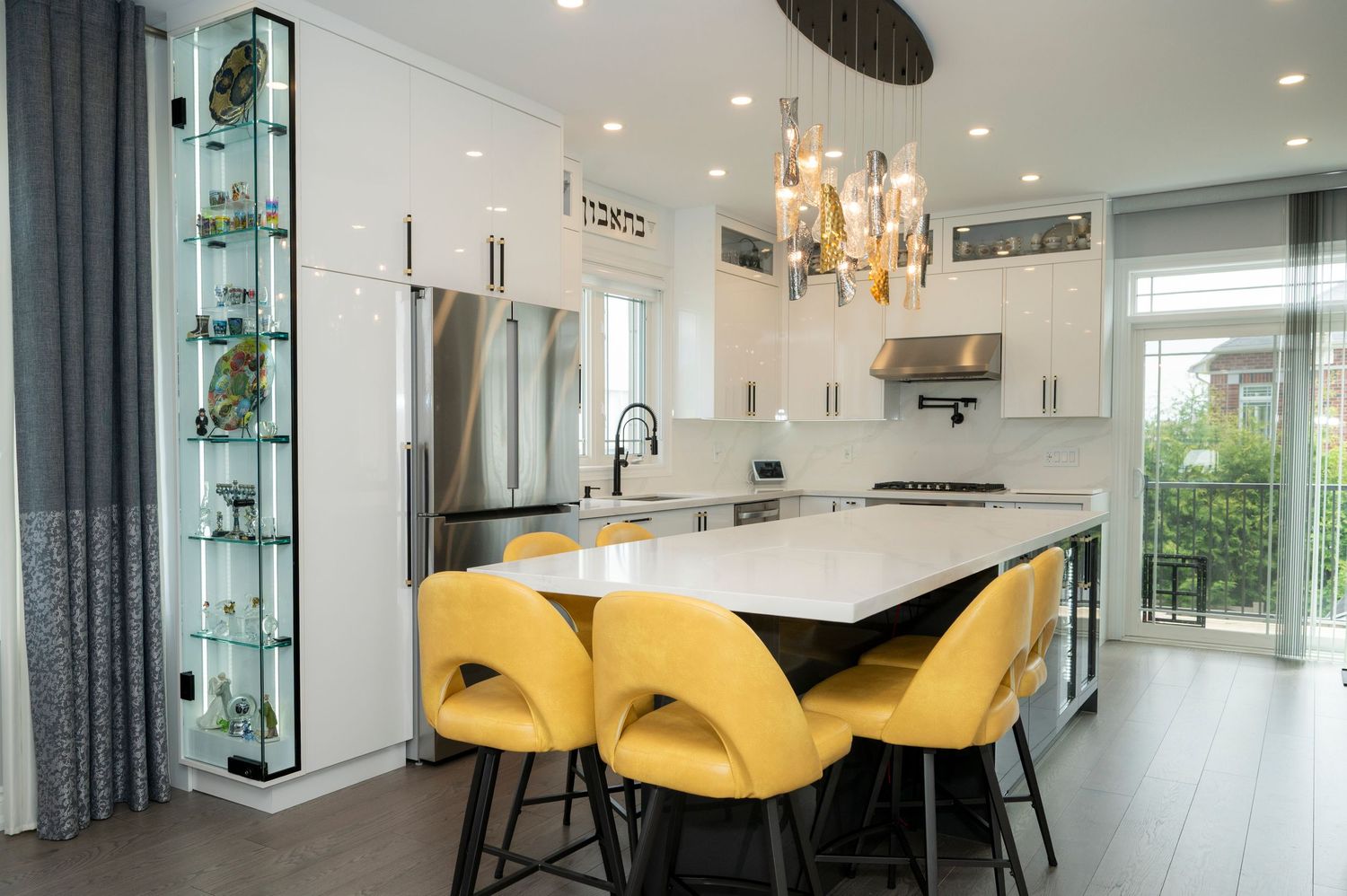 Modern family kitchen with yellow chairs and a contemporary ceiling lamp, captured for real estate photography by Alex Korin.