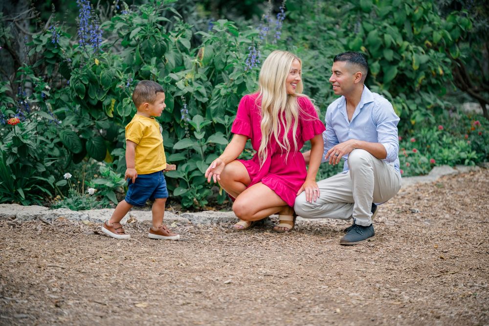 Family photo session in a lush garden in Huntington Beach, California.