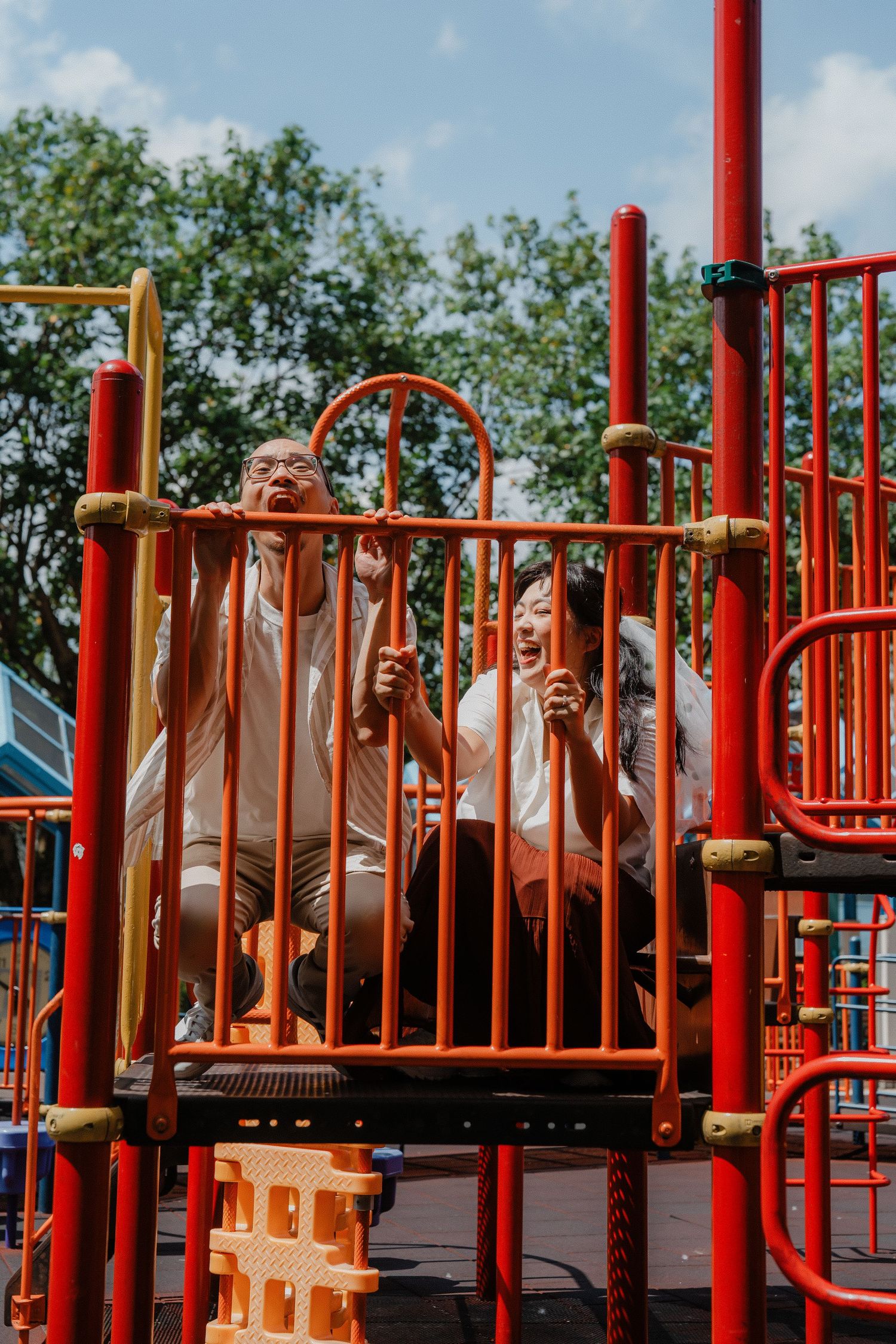Three playful images on red playground equipment showing joyful expressions and movement at a park.
