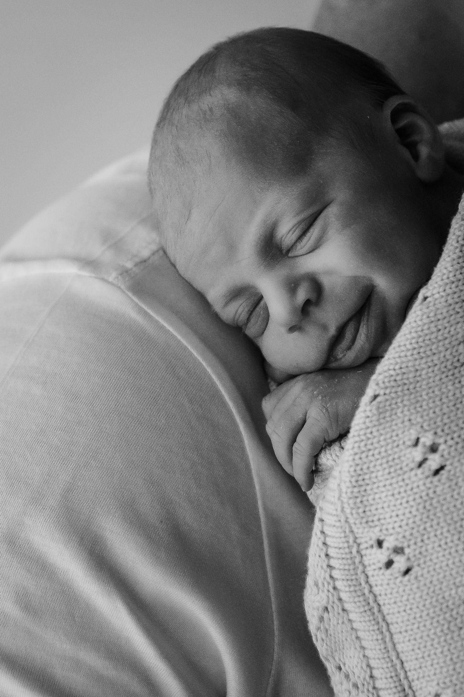 Peaceful sleeping portrait in black and white with delicate knit texture details.