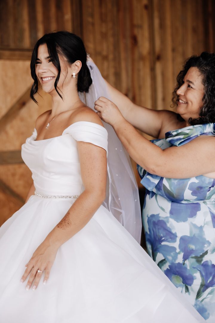 A series of candid moments between wedding attendees in formal wear against a rustic wooden wall background.