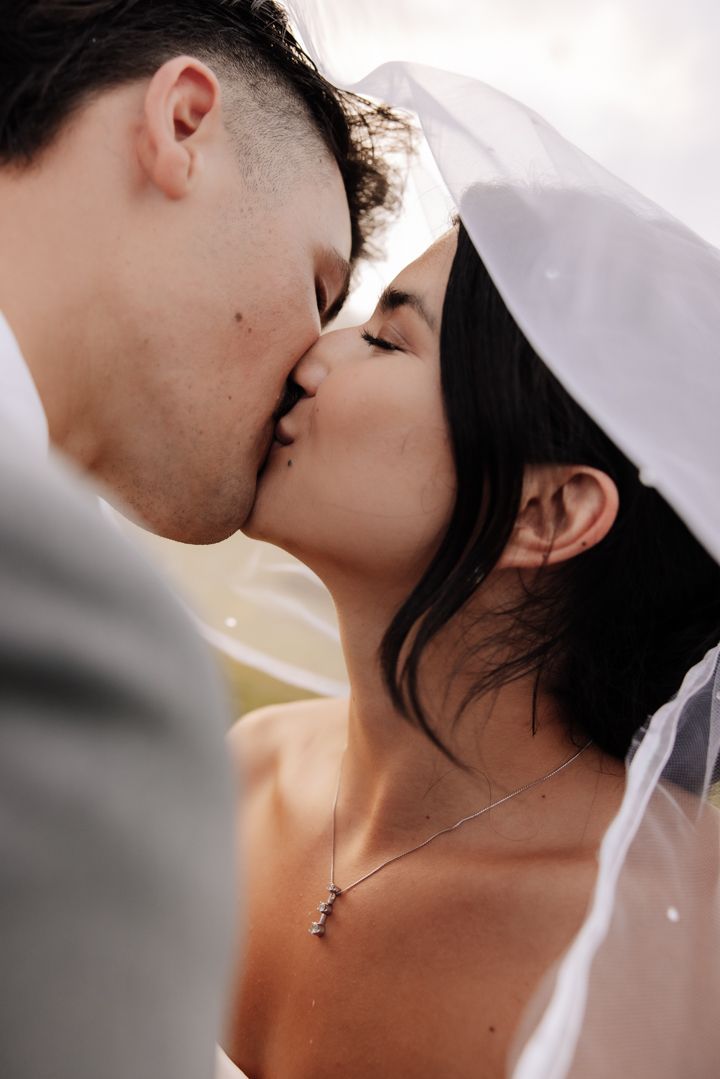 Black and white romantic close up of a couple sharing an intimate kiss.