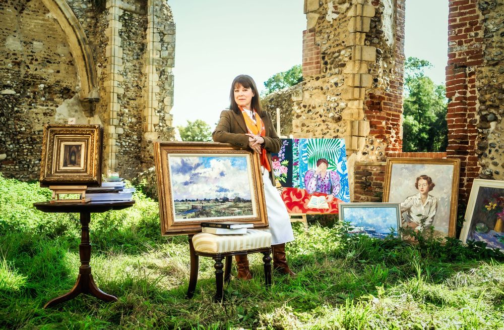 Editorial portrait of gallerist Lucy Charles displaying artwork in Yoxford, Suffolk