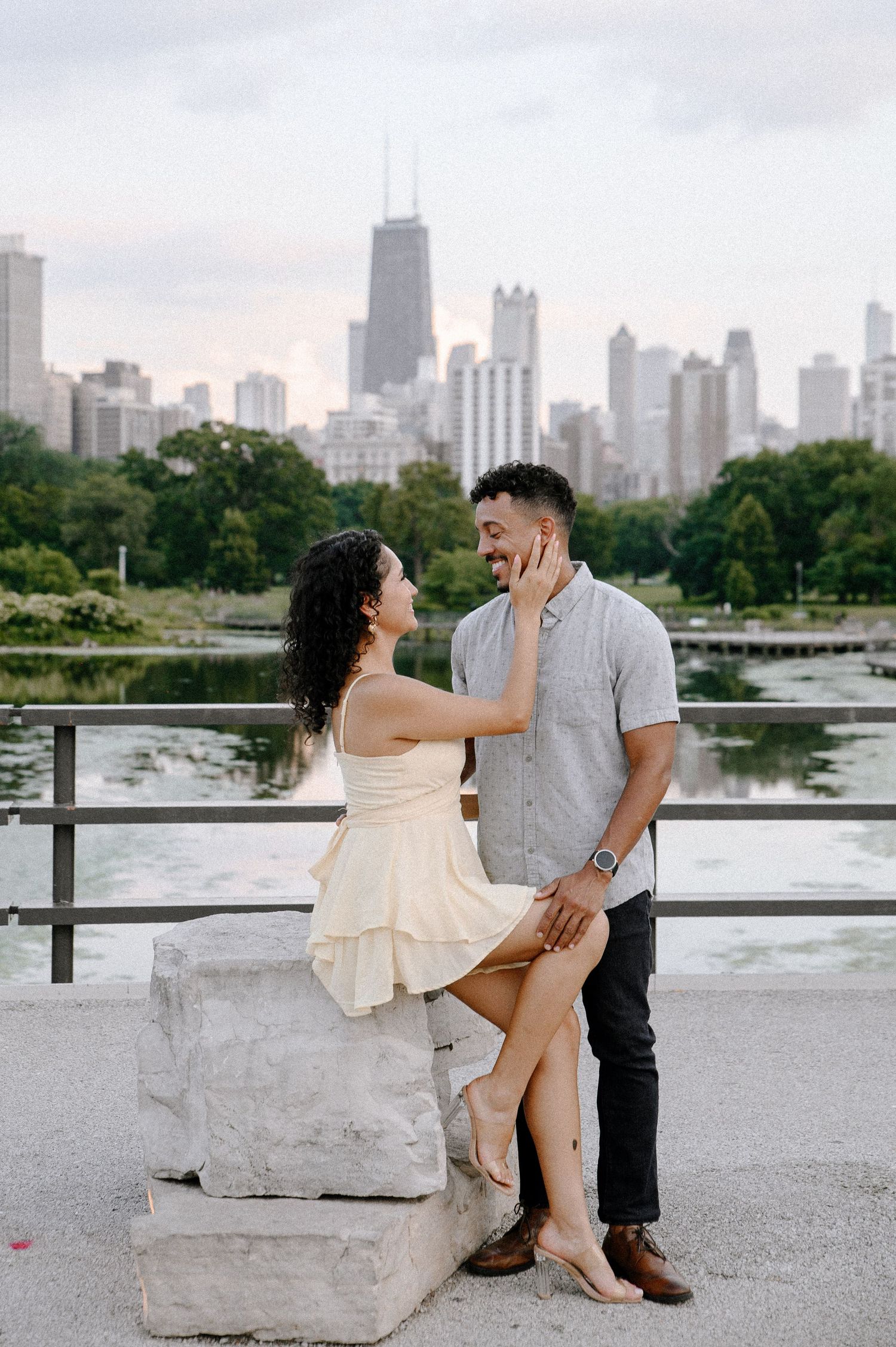 A romantic engagement session featuring a stunning Chicago skyline backdrop at Lincoln Park's North Pond boardwalk.