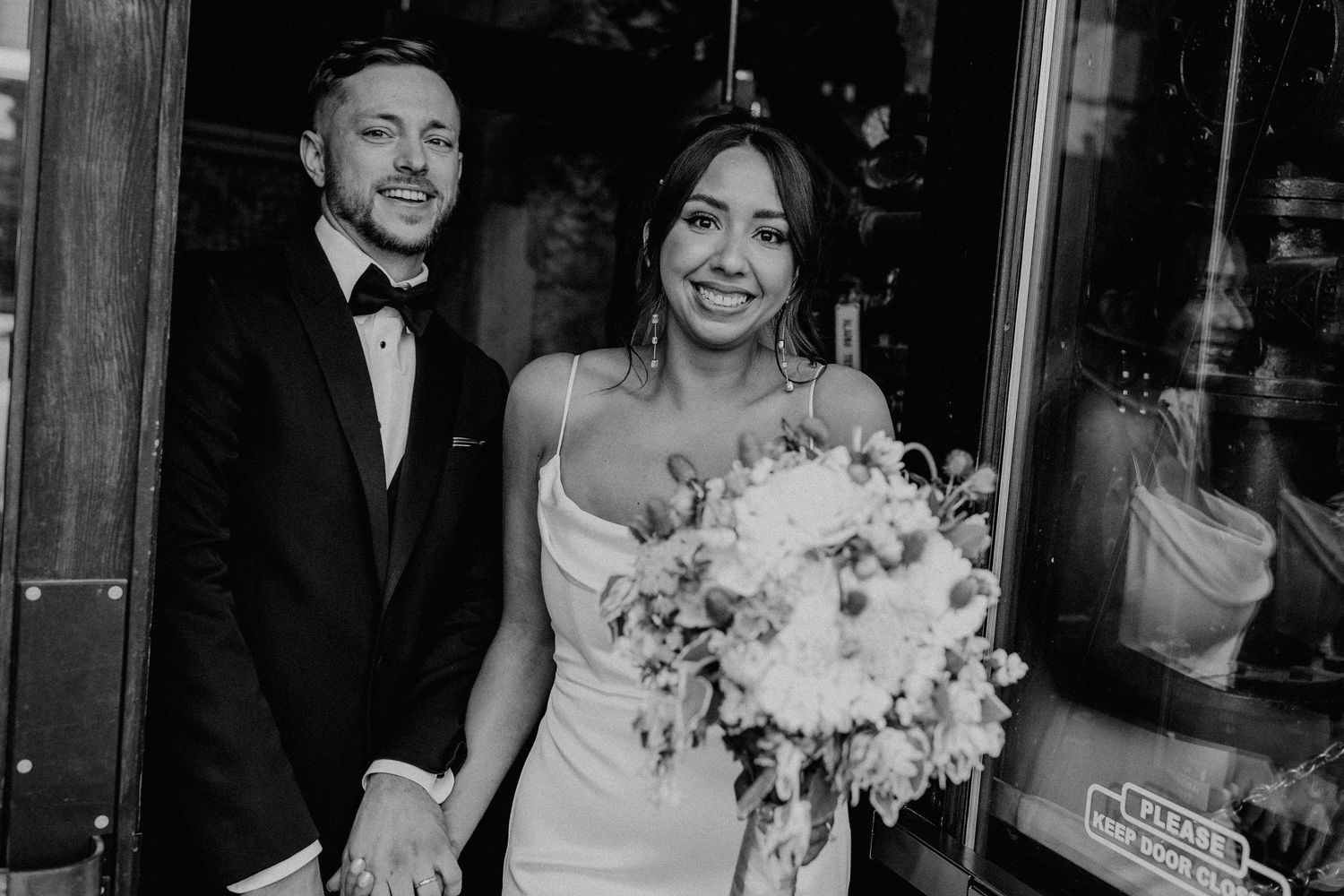 Textured white wedding dress with dramatic shadows cast across its surface in black and white.