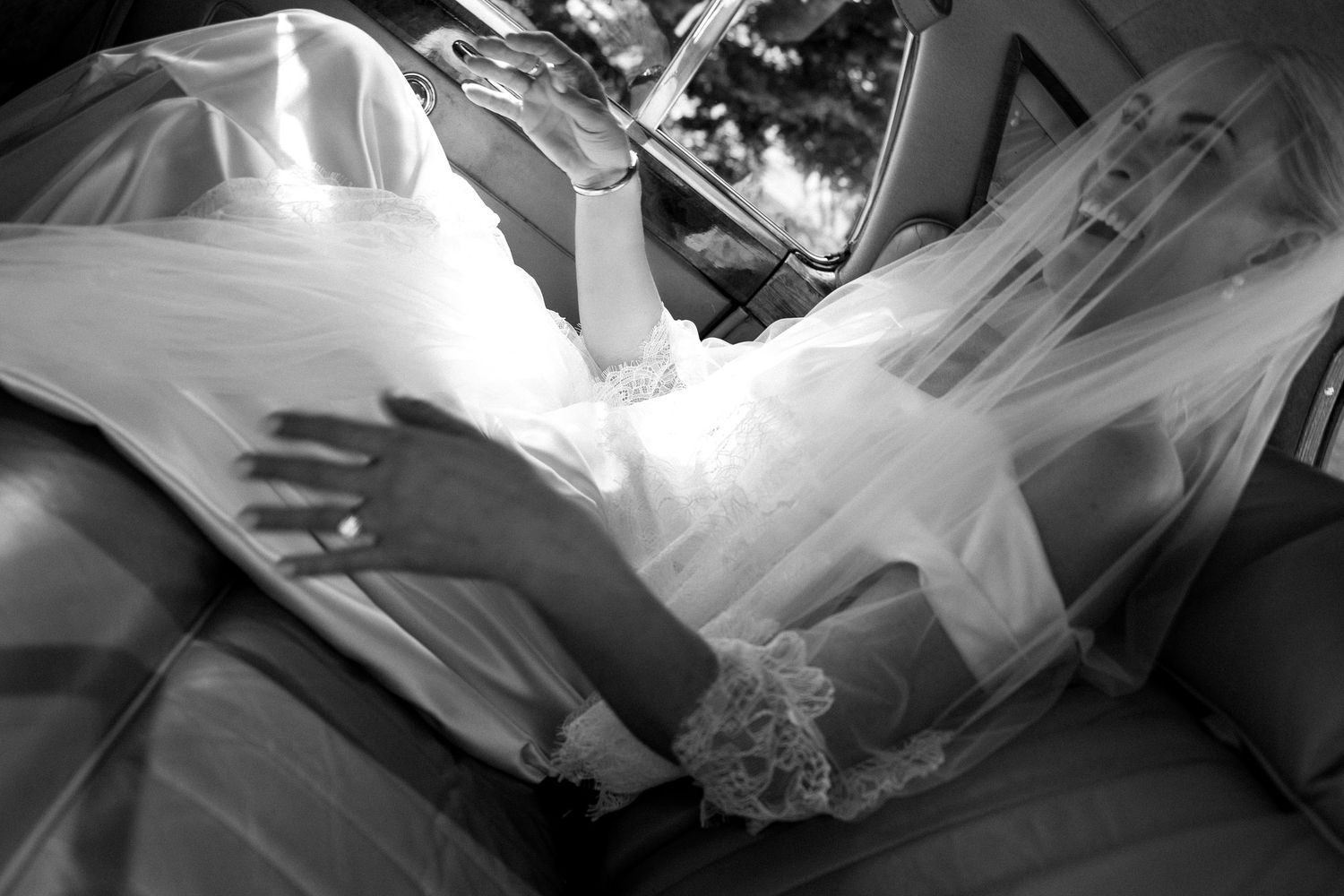 Textured white wedding dress with dramatic shadows cast across its surface in black and white.