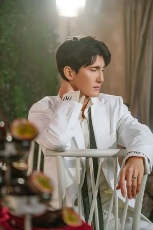 Side-by-side photos show a person in a crisp white outfit seated by white flowers in an elegant indoor setting.