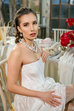 A series of romantic bridal portraits featuring a white strapless gown with floral accents and elegant jewelry.