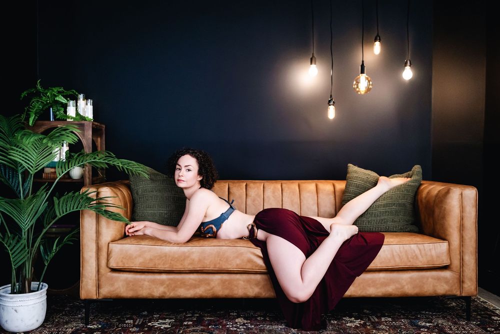 A sequence of boudoir photography shots on a brown leather couch with soft lighting and indoor plants in the background.