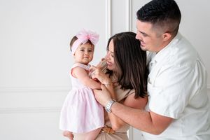 Family sharing tender moments together in a series of four connected black and white lifestyle photographs.