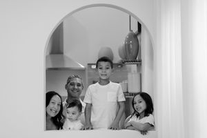 A collage of black and white family photos arranged in a horizontal strip showing candid moments at home.