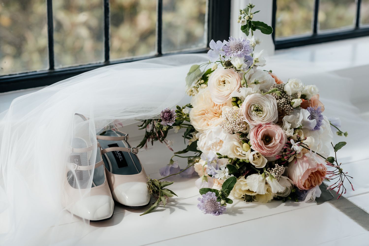 August & Vine wedding Photography of pastel rose bouquet and white & pink bridal shoes in a window box