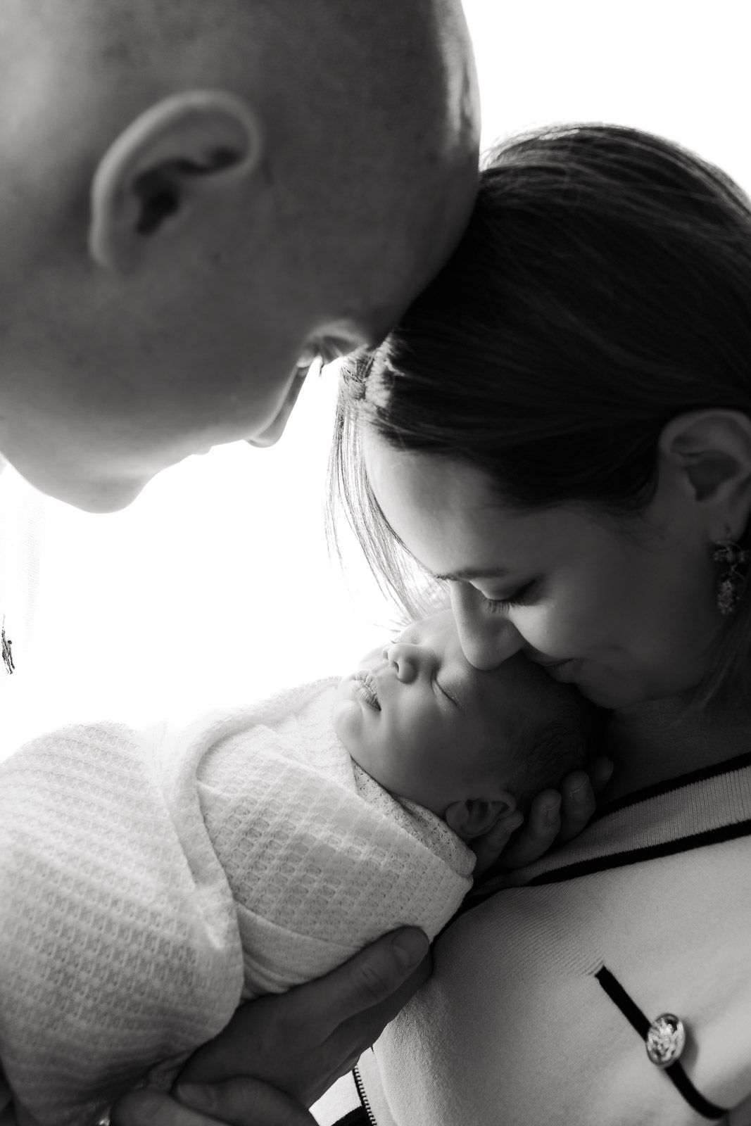 A black and white photo sequence showing a tender moment between two people in close embrace.
