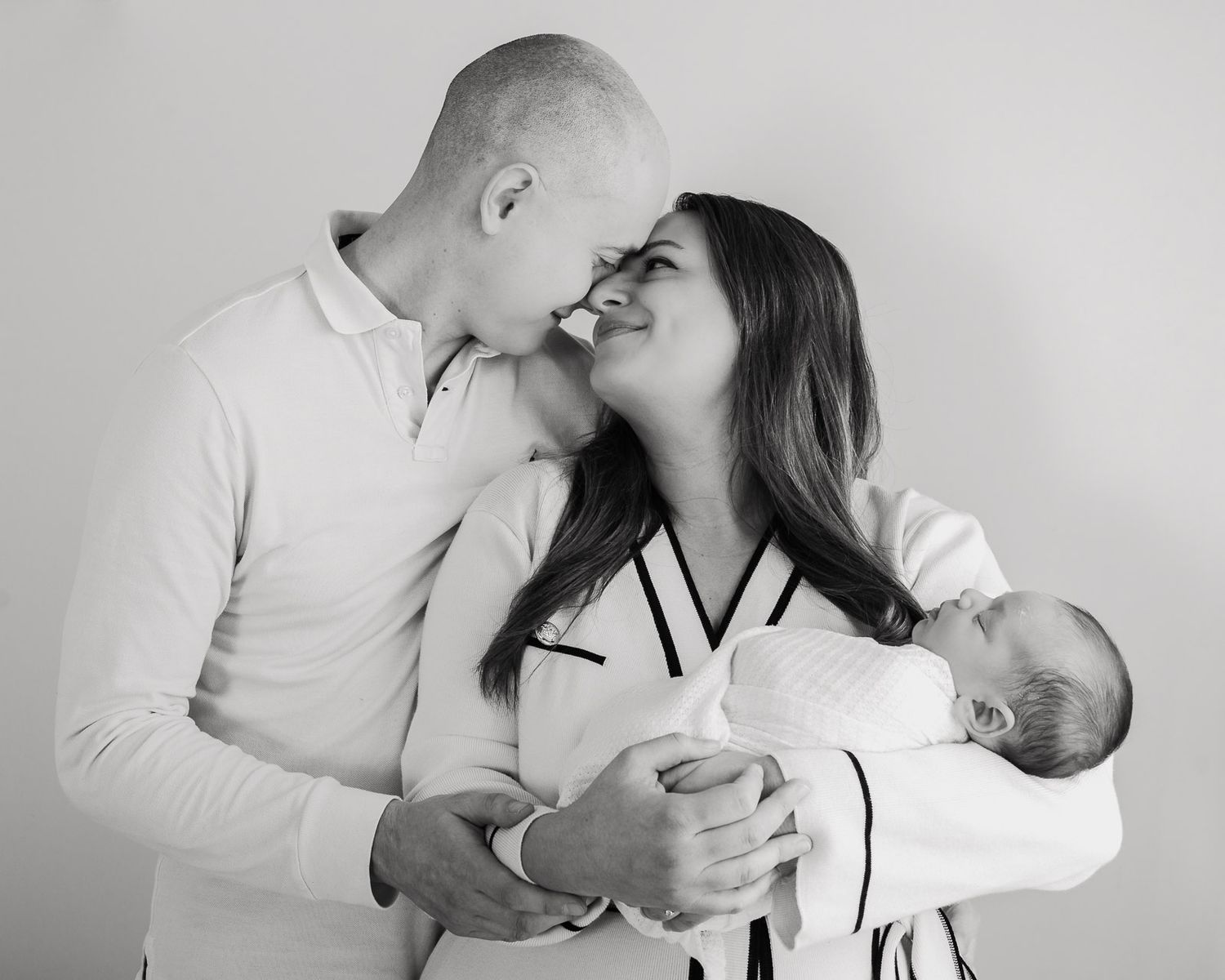A series of romantic black and white photos showing a couple embracing and sharing tender moments together.