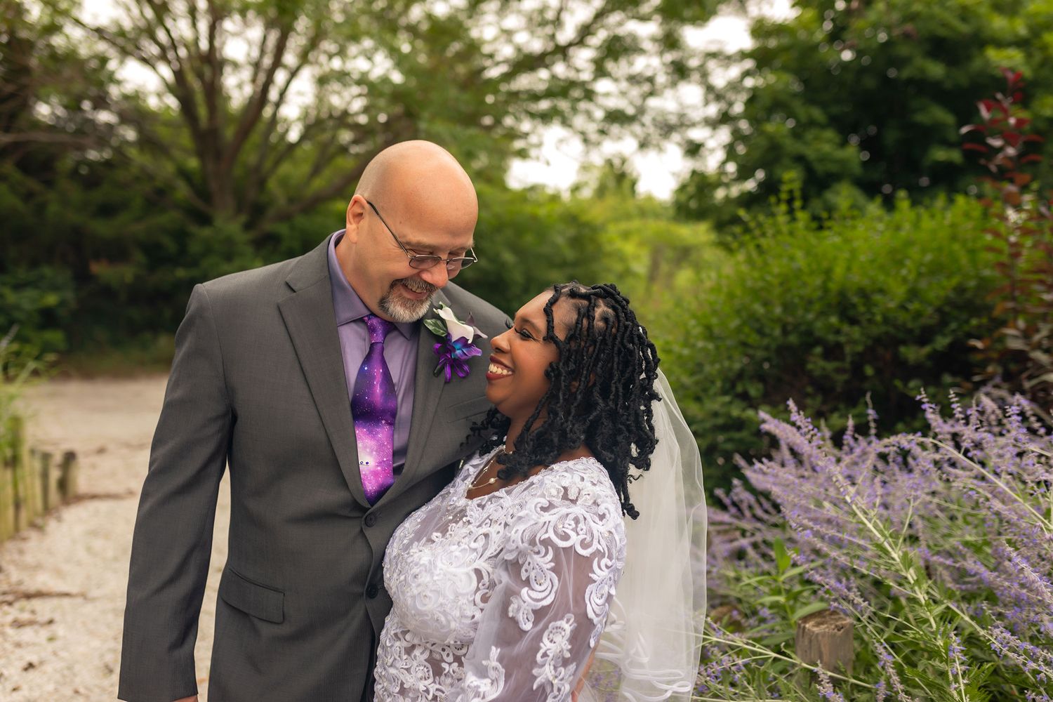 Romantic garden wedding photos with blooming lavender flowers.