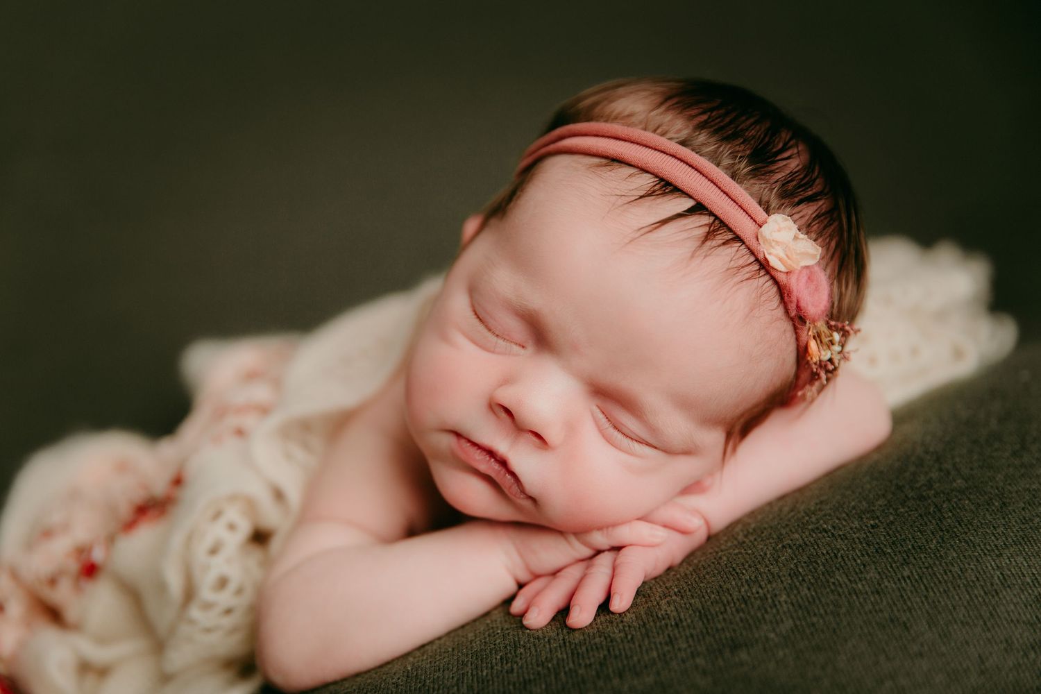 newborn baby girl sleeping during studio photoshoot in kansas city area photography studio