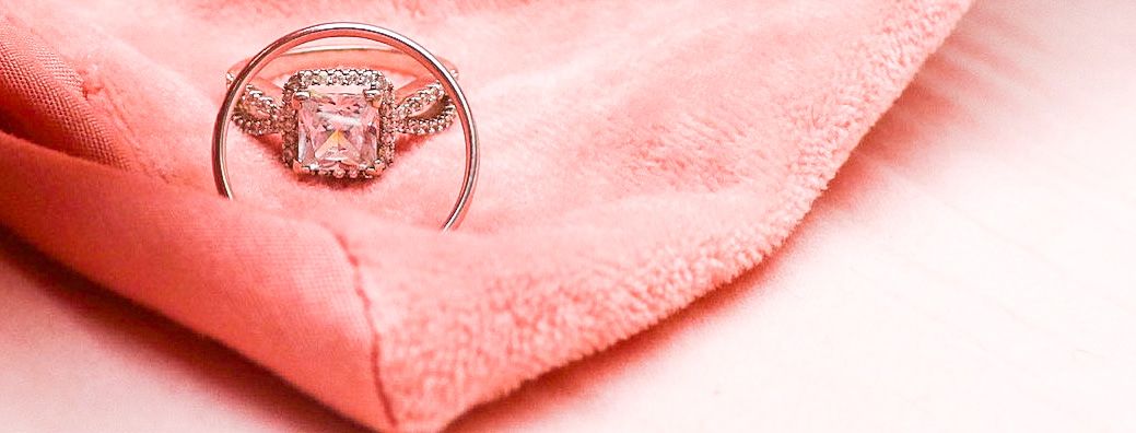 Close-up details of a sparkling diamond engagement ring with delicate band design.