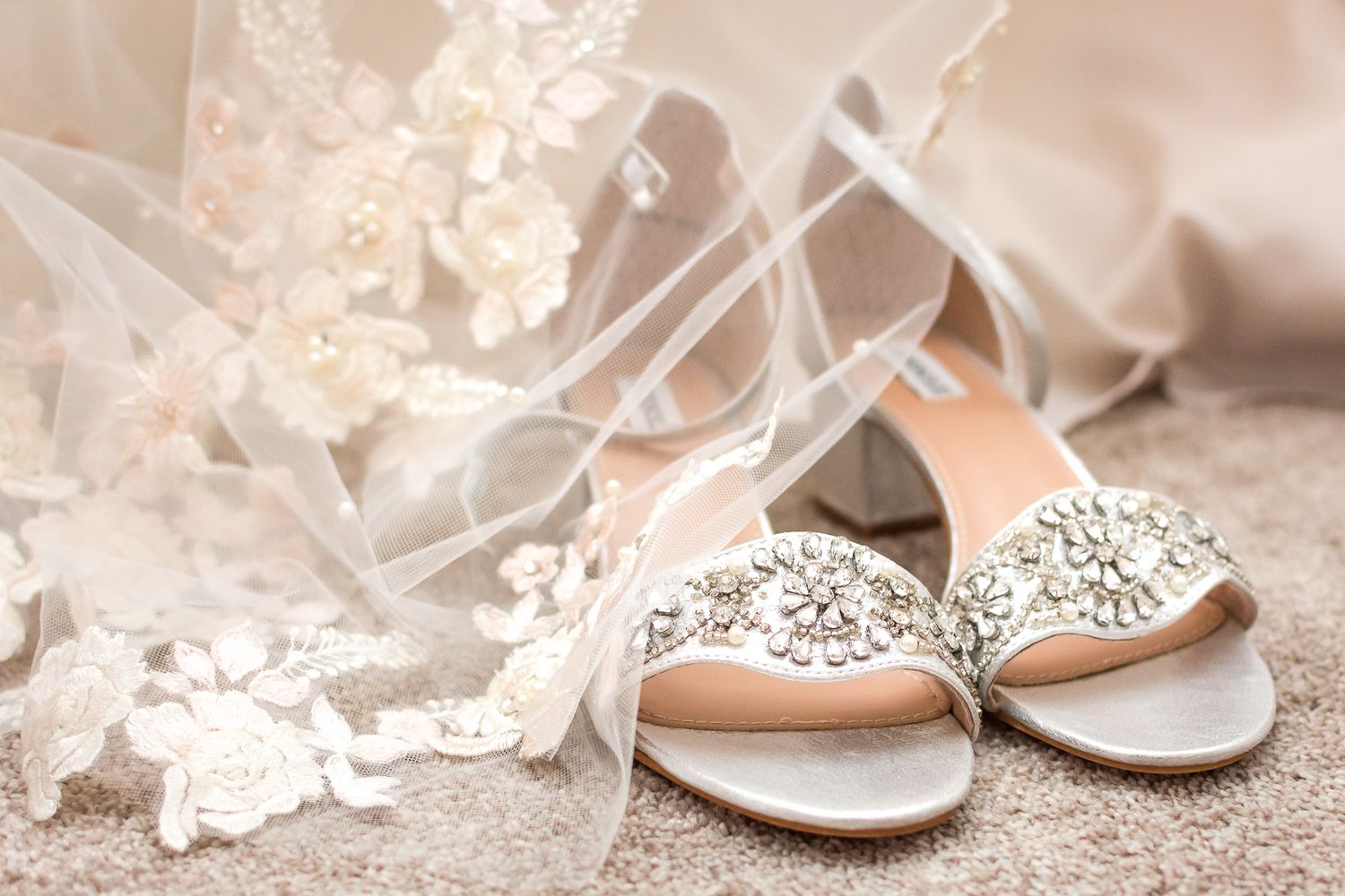 A close up image of a bride's shoes and veil on her wedding day. Photo taken in Vancouver by Kari Mills Photography.