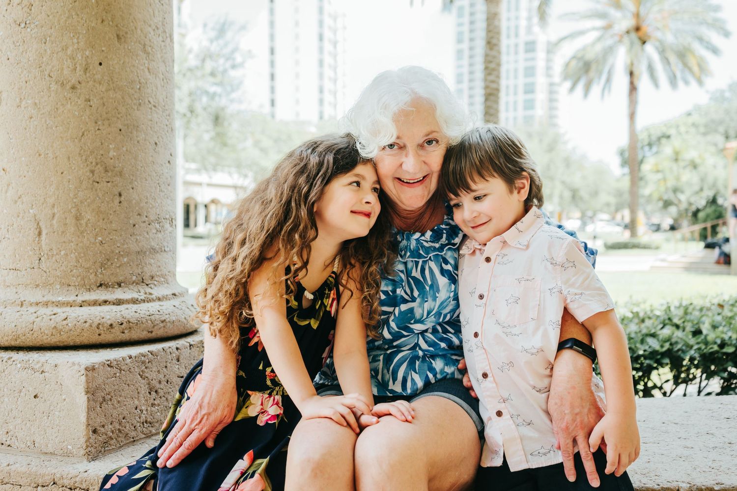Outdoor Family Session in St. Pete, FL; Grandmother posing with grandkids near museum