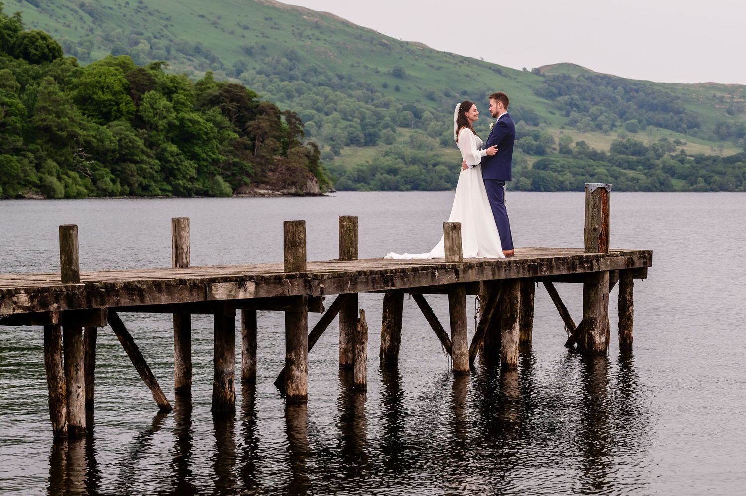 Bride and groom on jetty at Inn on the Lake wedding