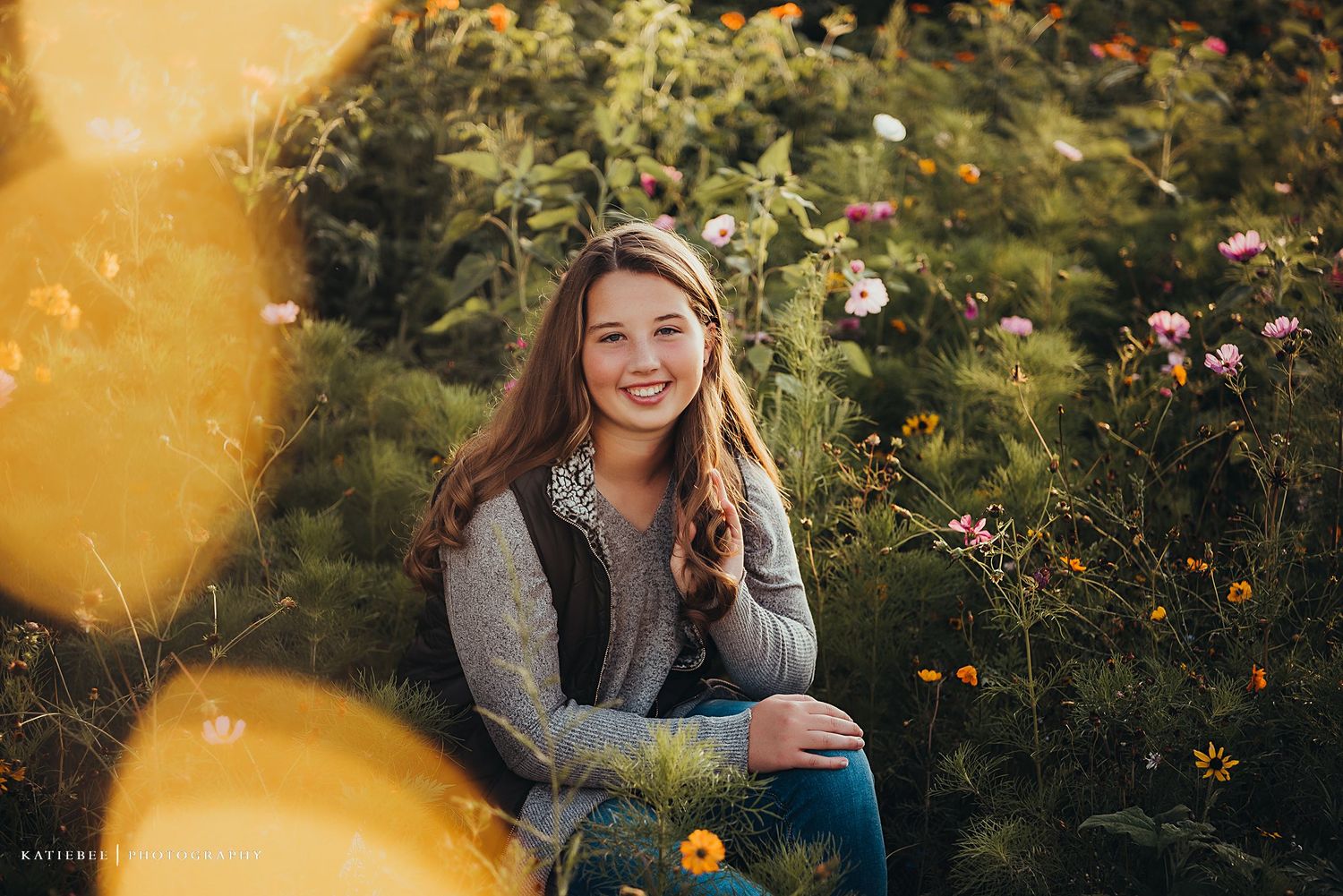 Portrait in a garden with soft golden lighting and blooming flowers in the background.