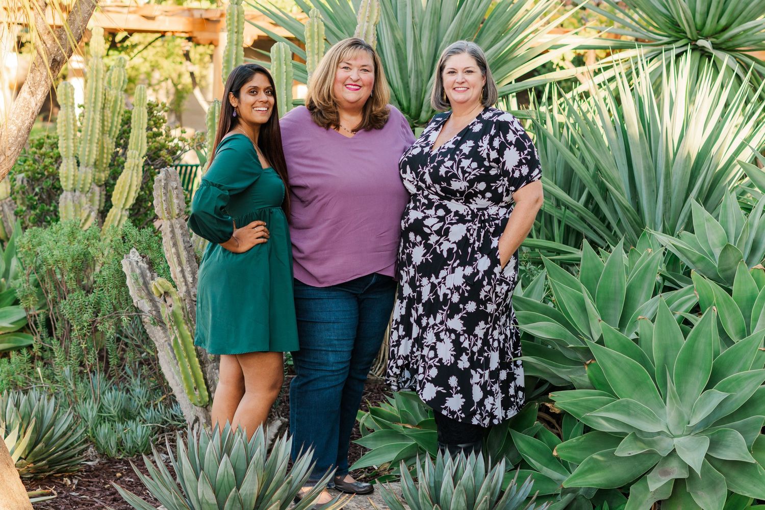Team headshots for the women of Embodied Wisdom Counseling standing in a succulent garden in downtown SLO