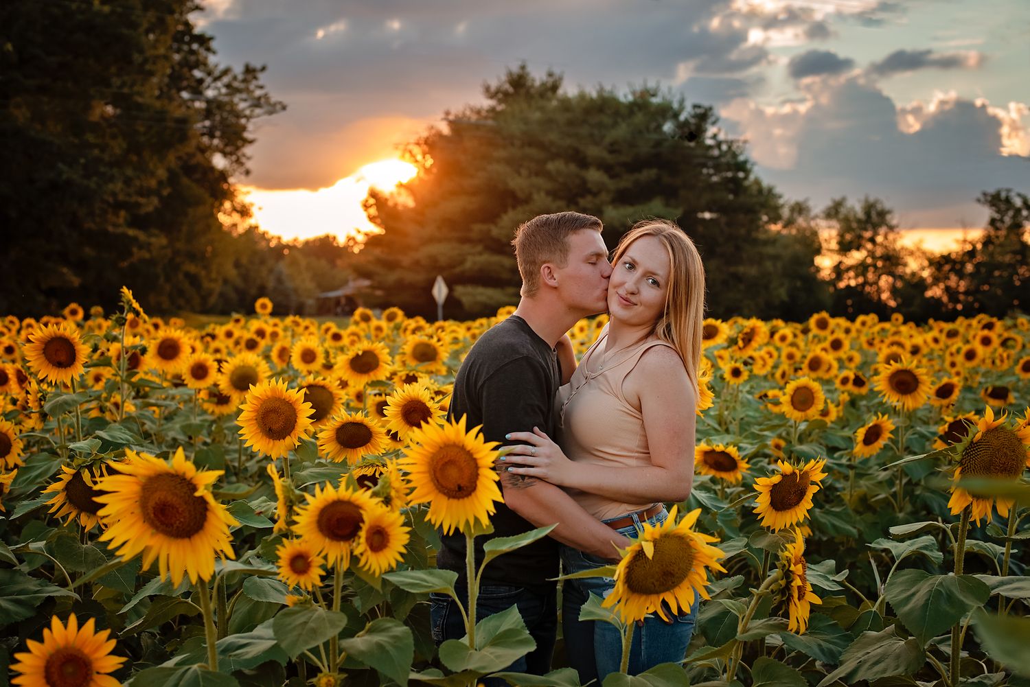 Couple in sunflower field at sunset in Cleveland Ohio for engagement photo session with Angie Russell Photography LLC