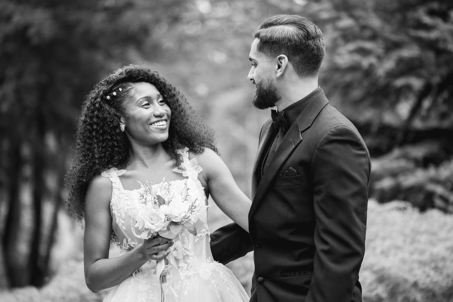 A joyful moment shared between newlyweds in a garden setting.