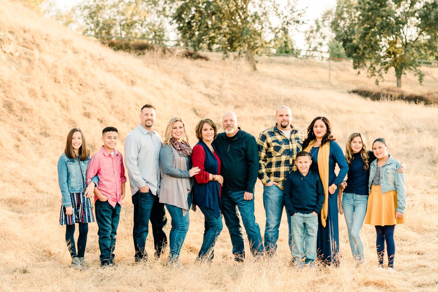 A multigenerational family photo on a hillside at Woodward Park in Fresno by Felisha Connolly Photography
