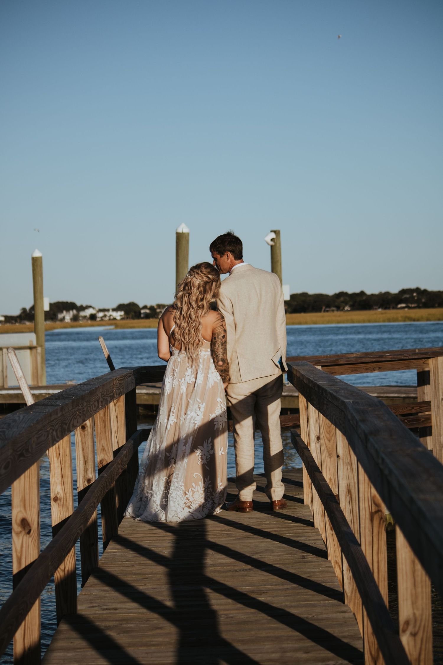 A couple walks away on a dock at Goldbug Island