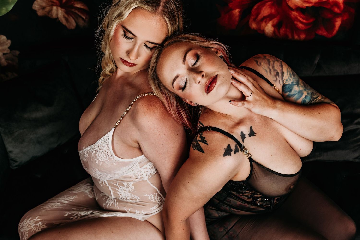 Close-up portrait shot of two women in an intimate romantic pose with white lace lingerie. Luxury boudoir photography Grand Rapids