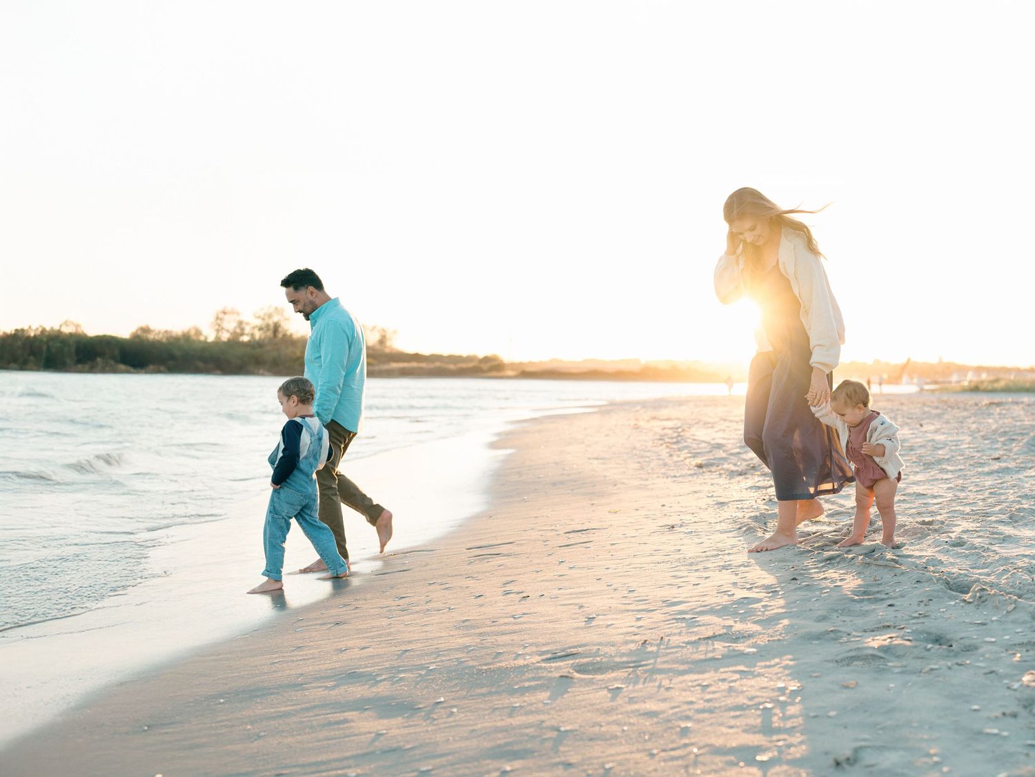 A family of four plays by the water at fisherman's cove in manasquan, nj.